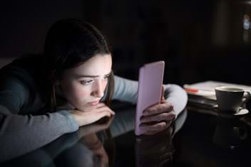 Girl scrolling social media looking unhappy